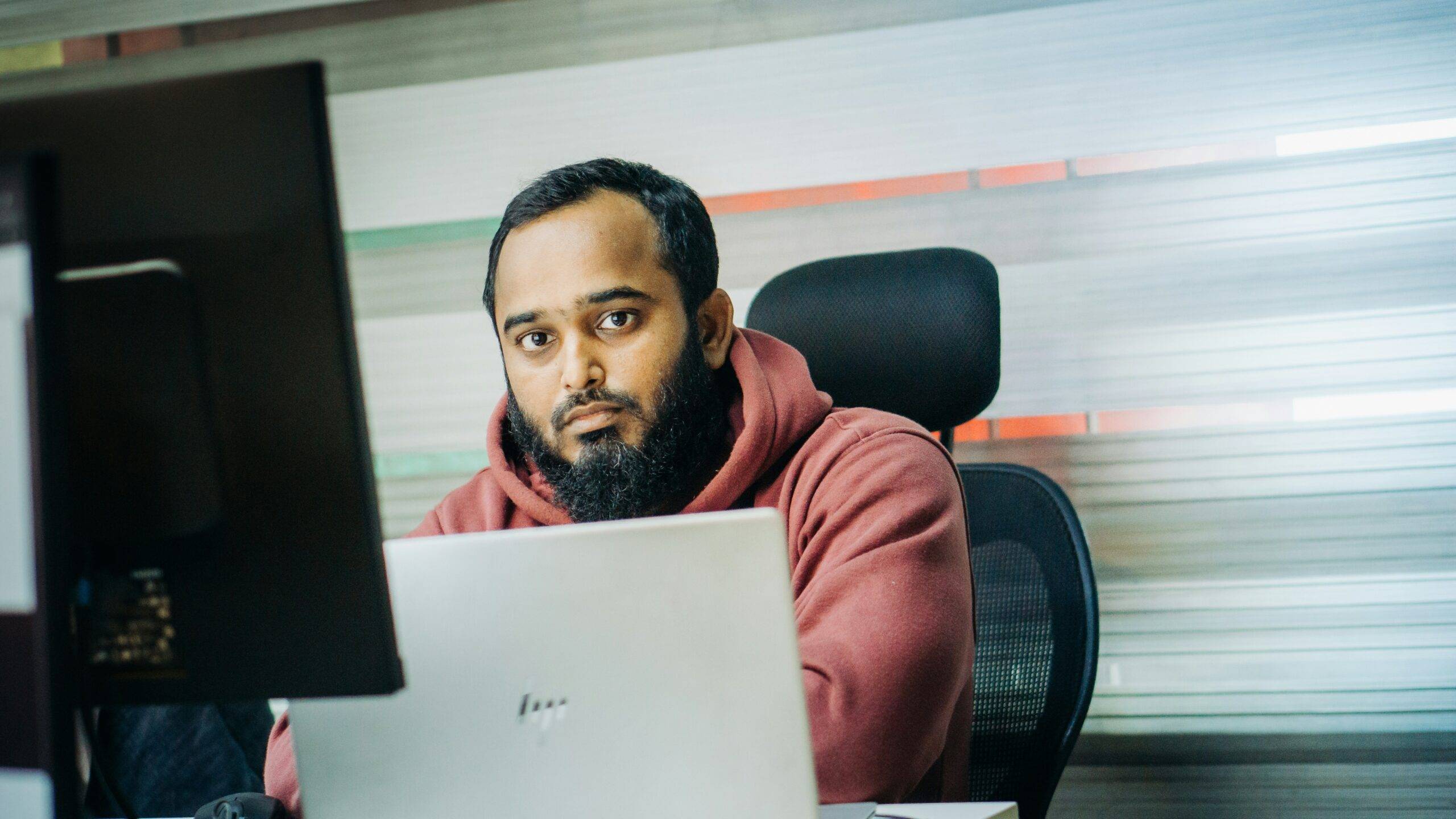 Person looking confused while staring at multiple analytics dashboards